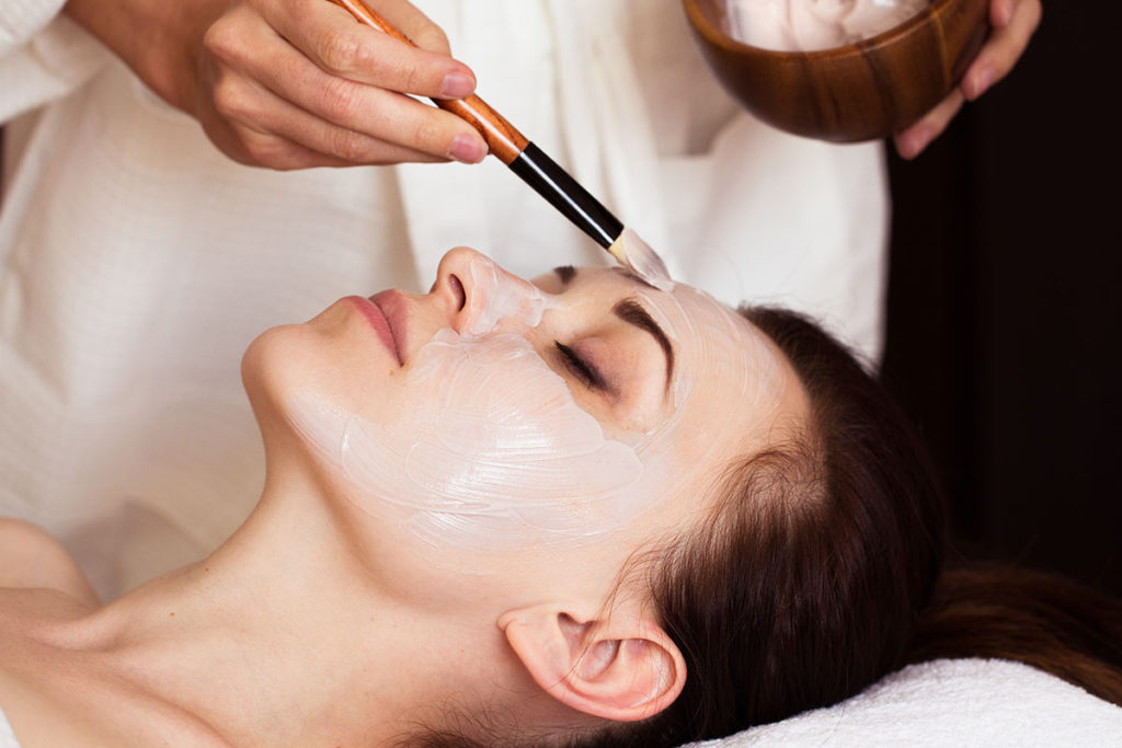 Spa treatment. Beautiful woman with facial mask at beauty salon. Beautiful woman with facial mask at beauty salon. Spa treatment